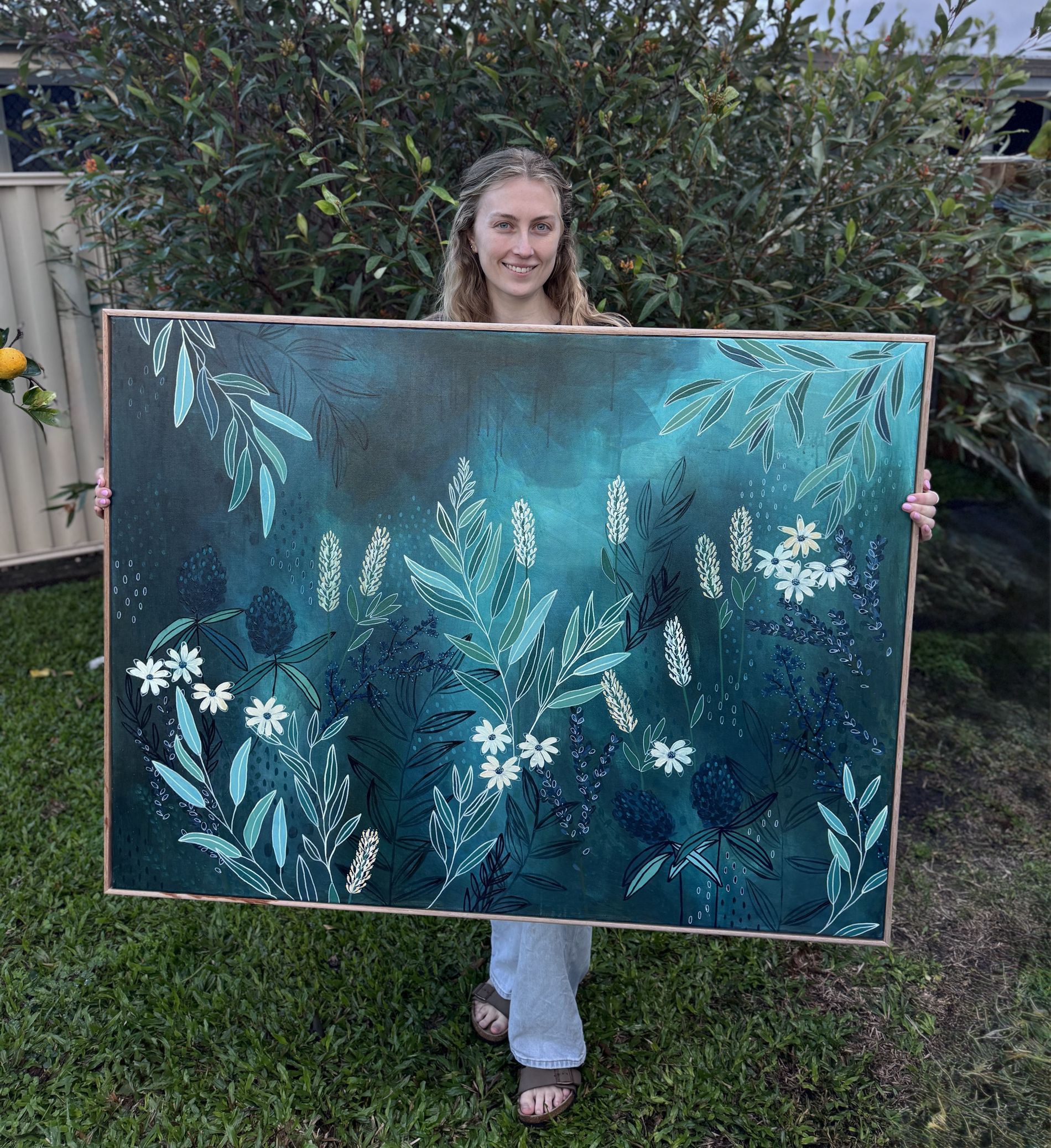 Abby holding her painting Twilight Bloom